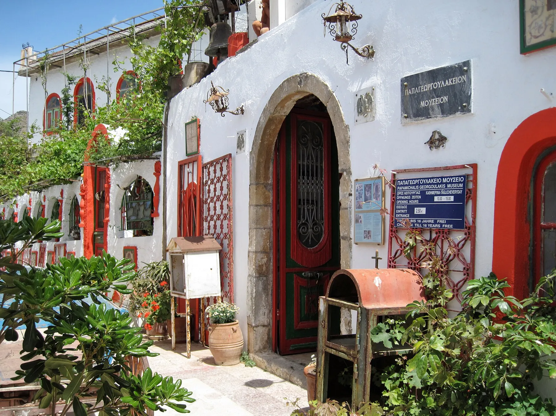 Whitewashed house fronts and plants in Asomatos village