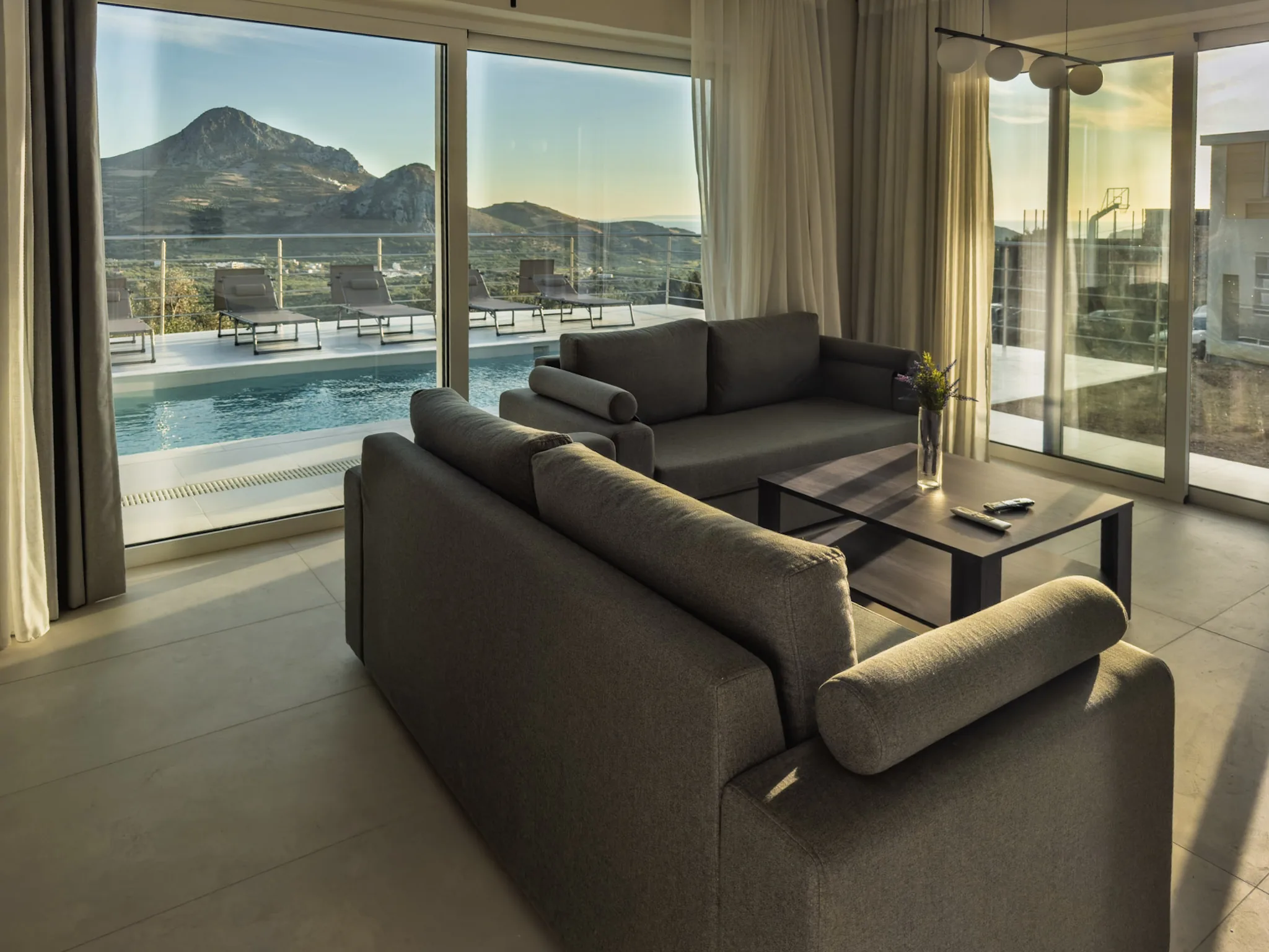 Pool House living room with glass doors to the pool and the peaks