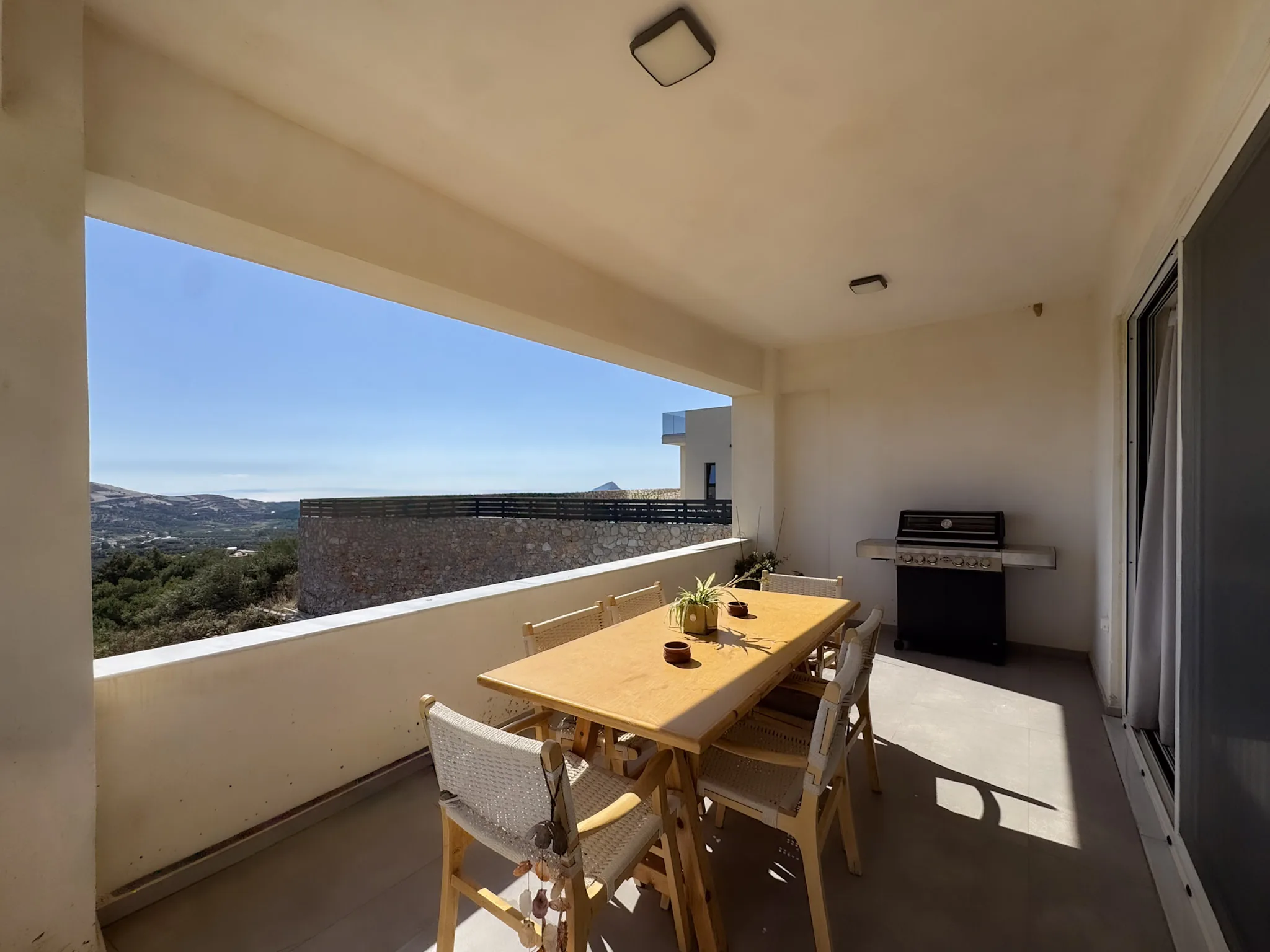 Covered dining terrace of House Two with the mountains beyond