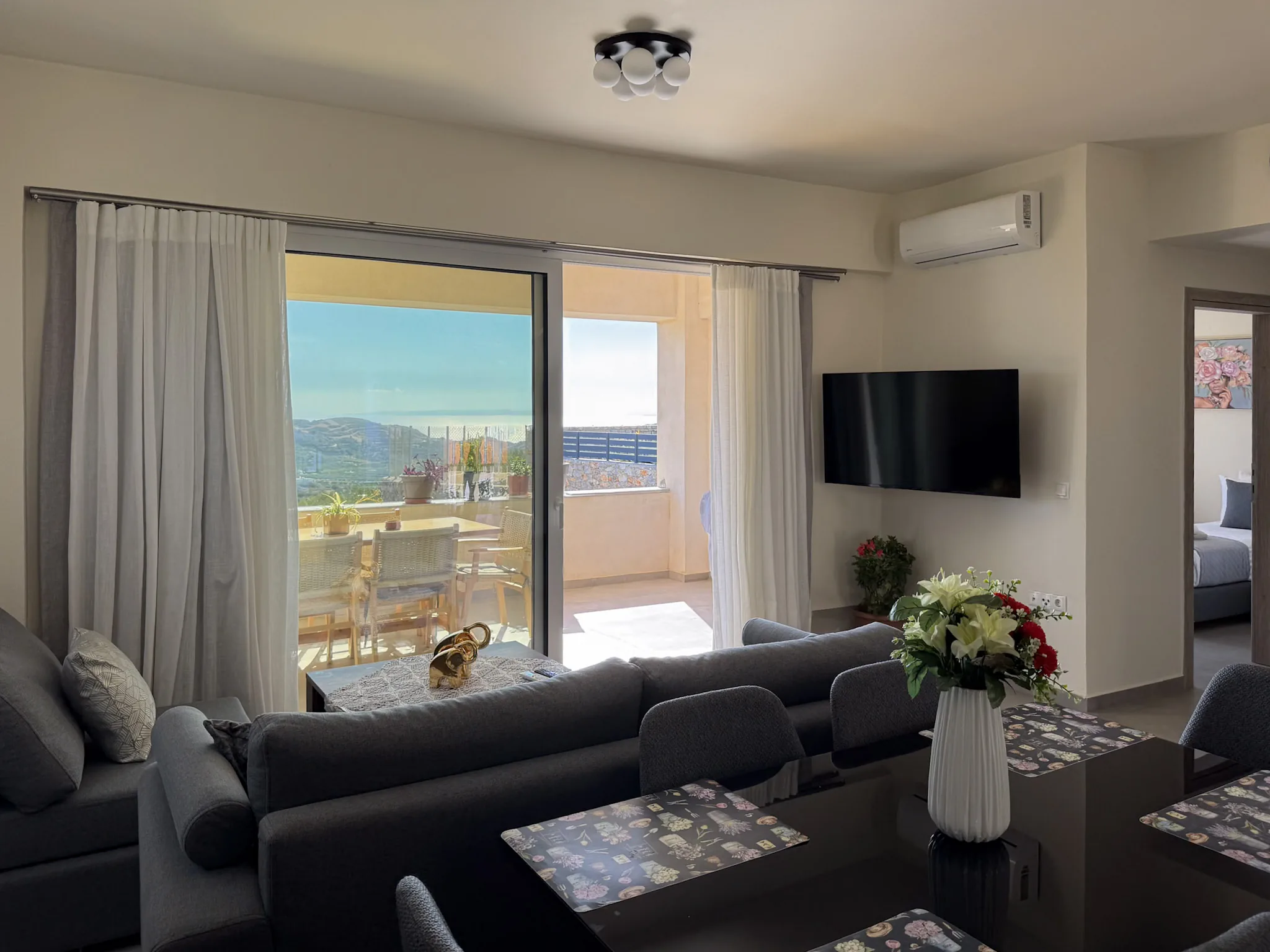 House Two living and dining room with doors to the terrace