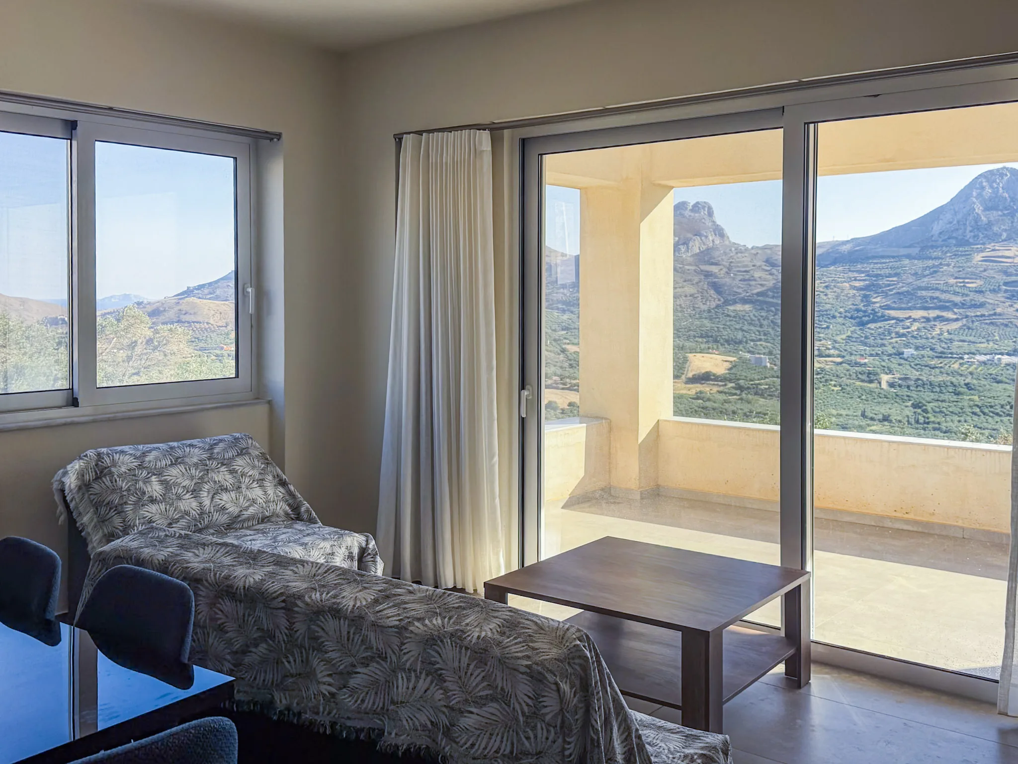 House One living room opening to the balcony and the peaks