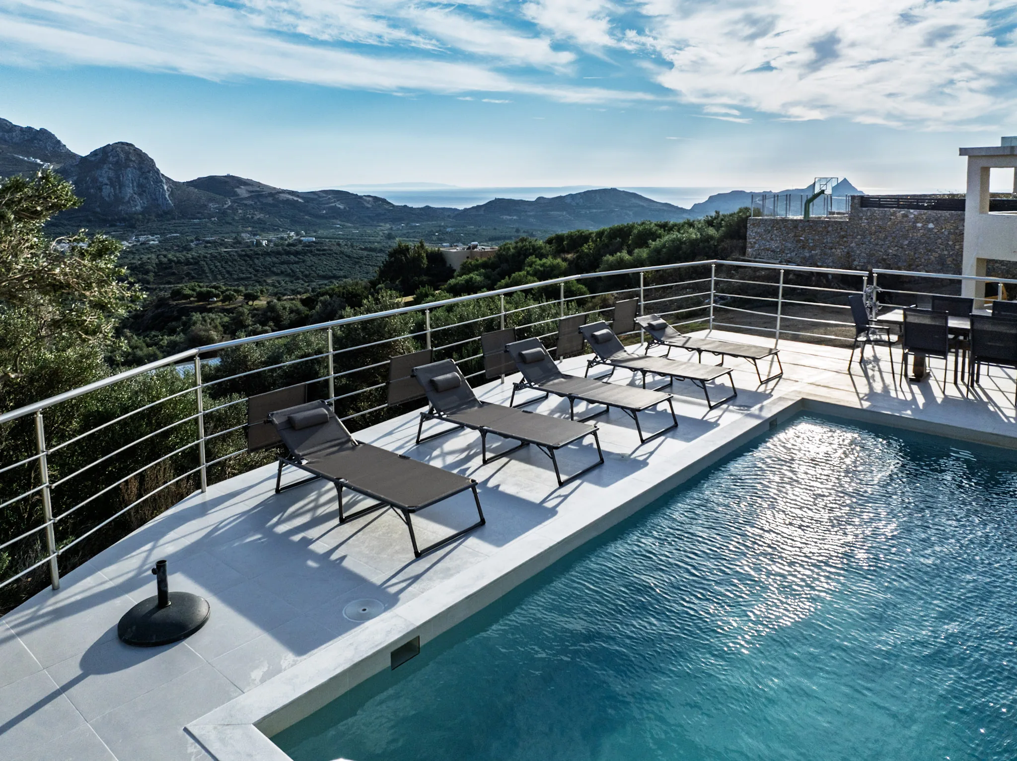 The Pool House pool and terrace from above, mountains behind